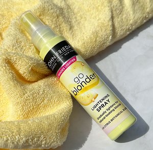 John Frieda's Go Blonder Lightening Spray on a yellow towel 
